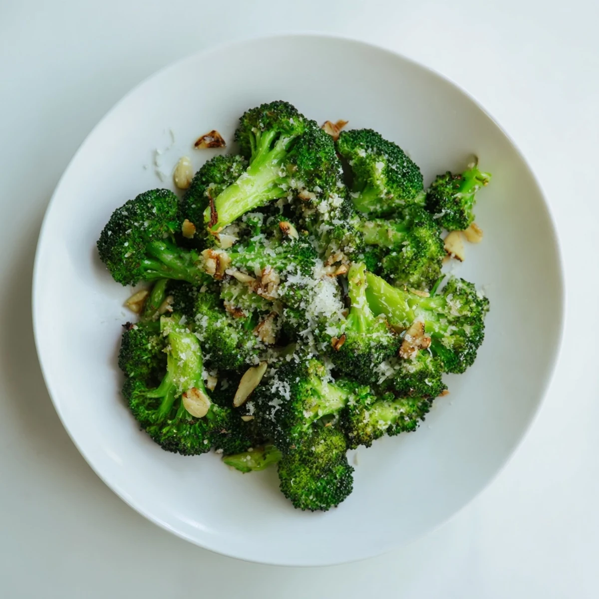 Golden-brown Simple Garlic and Parmesan Roasted Broccoli speckled with Parmesan, ready to serve warm.