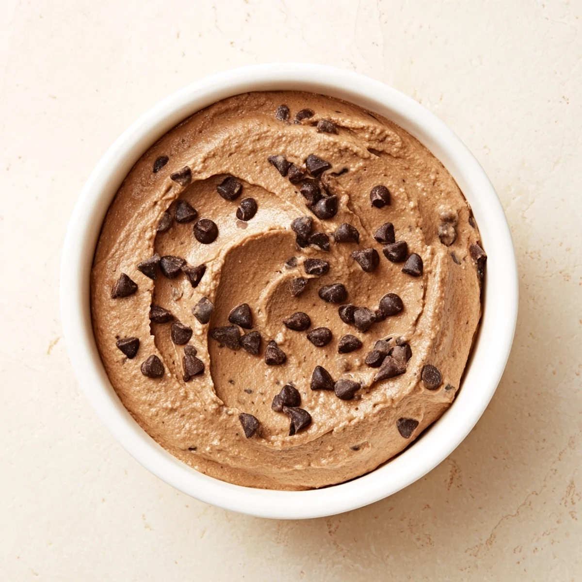 A bowl of rich, dark chocolate hummus, a healthy and delicious dessert dip.