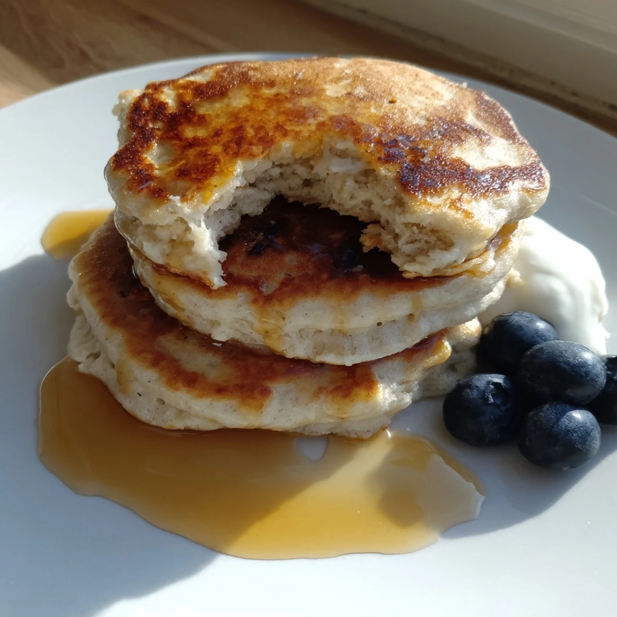 Golden-brown Protein Banana Pancakes, ready to be flipped on a hot griddle for breakfast.