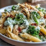 Creamy High Protein Rotisserie Chicken Broccoli Pasta garnished with fresh parsley and grated Parmesan cheese, ready to serve.