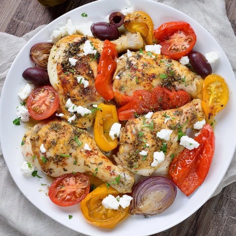 Golden, roasted Easy Sheet Pan Greek Chicken alongside vibrant bell peppers and tomatoes, ready to enjoy.