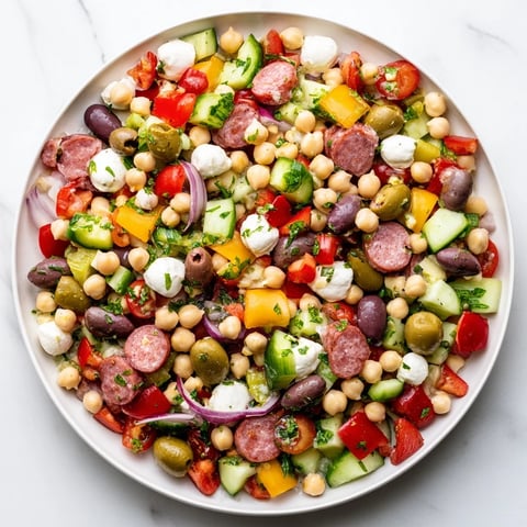 Crunchy Antipasto Chopped Salad features vibrant chickpeas, salami, and mozzarella tossed in zesty Italian dressing.