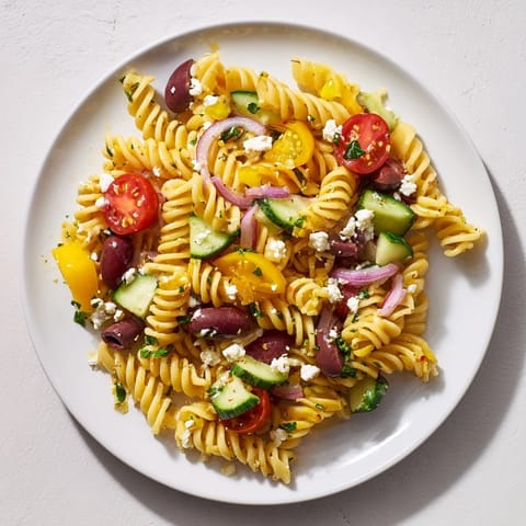 A refreshing bowl of Lemon Pasta Salad featuring colorful veggies and creamy feta cheese.
