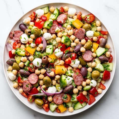 Crunchy Antipasto Chopped Salad features vibrant chickpeas, salami, and mozzarella tossed in zesty Italian dressing.