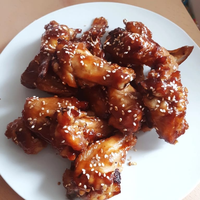 Enjoy flavorful honey-chili glazed chicken wings, a delicious and easy American appetizer ready to serve.