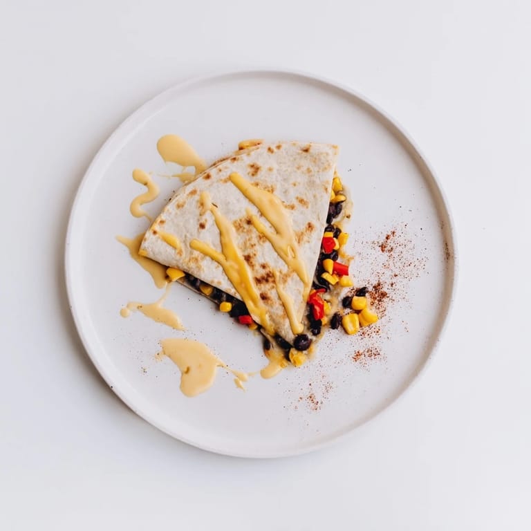 A close-up shot of cheesy Quick Black Bean and Corn Quesadillas ready to be served with salsa.
