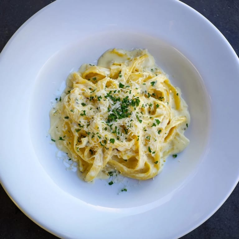 A close-up of the perfect 20-minute creamy Alfredo pasta, showcasing the velvety Parmesan sauce and noodles.