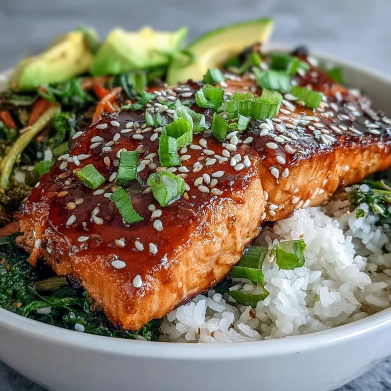 A close-up of a Soy Ginger Salmon Bowl featuring seared salmon, vibrant stir-fried veggies, and steamed rice for a healthy meal.