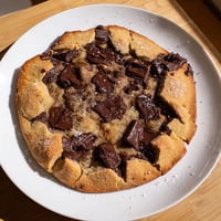 Golden-brown Warm Chocolate Chunk Skillet Cookie with melted chocolate, ready to be served warm.