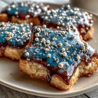 Pisces constellation sugar cookies with royal icing depicting stars and celestial lines on a navy blue background.